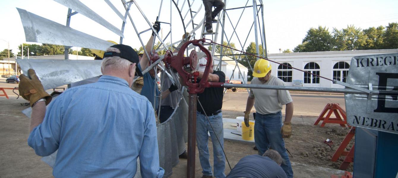 team putting together windmill